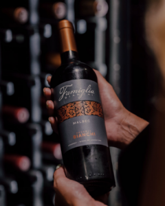 Famiglia Bianchi Malbec – Beauty – Holding Bottle