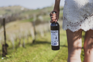 Passato Barbera d’Alba, Made with Organic Grapes – Beauty – Woman holding bottle